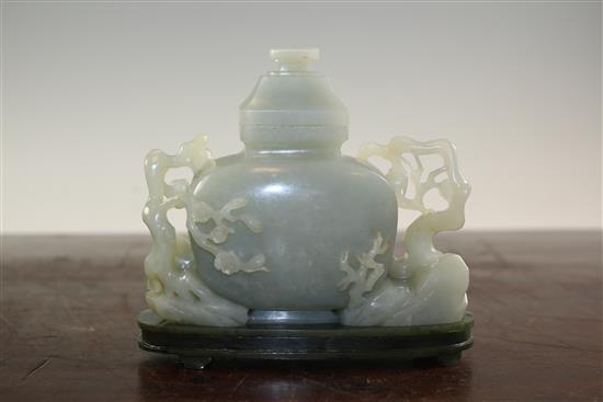 A Chinese pale celadon jade vase and cover, with spinach green jade stand, Qing dynasty or later, 4.3cm., width 13.5cm., fitted rosewoo